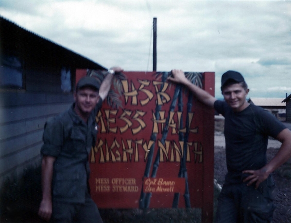 Hqs Service Battery, Mess Hall at Camp Enari
Sp5 John O. Olson and Sp6 Bob McLaughlin holding up the Mess Hall sign.
