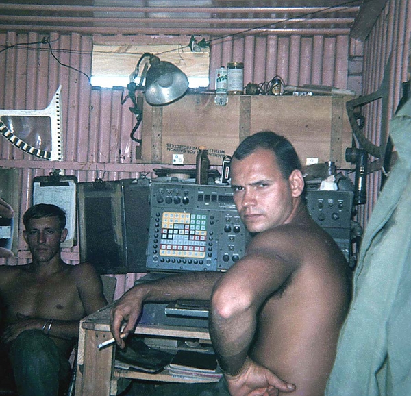 Inside the CONEX
Check this FDC out!  Lotsa cool memories.  Note the RDP fan at top left, a good look at the FADAC (center), a can of RISE shaving cream on the shelf, a standard GI flashlight clipped to the wall at right and a guy wondering (Dietrich) why you want to take his picture.   That's Geary Burrows in the background.
