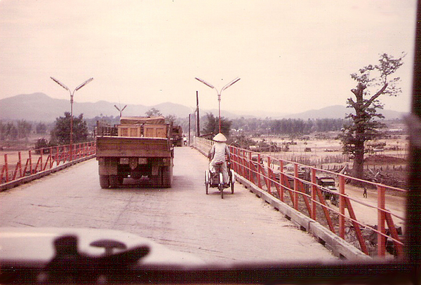 Kontum Bridge - LZ Mickey Mouse
Summer, 1968.  Kontum Bridge, which is just south of town on road going south to Pleiku.  We frequently swam below the bridge & it was a popular watering hole for Kontum residents and an occasional water buffalo.  Area wasn't always safe: the NVA vowed to take the bridge & city for Ho Chi Minh's birthday.  Also saw a Viet cop kill a VC suspect here.

