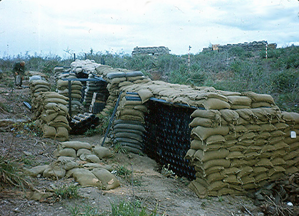 Break from S&D
Search & Destroy missions were shared among the Infantry companies with one company taking a break for rest at a 105mm howitzer battery. They were known as the "Palace Guard" since they provided defenses for both their Battalion Command Post and one of the 105mm batteries.
Lt Keith was supported by "A" Battery, 2/9th FA. 

Howitzer ammo stacked and ready at LZ OD near Duc Pho.
