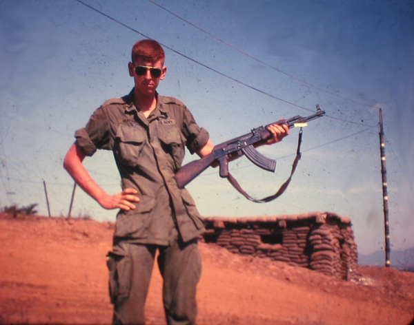 Lt Chris Herrick holds an AK-47
