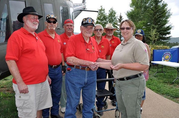 Presenting the 2/9th Challenge Coin
From left: Terry Stuber, Cowboy Danny Fort, Jim Connolly, John Severn, Bill Kull.  Foreground: Jerry Orr and Karen German.
