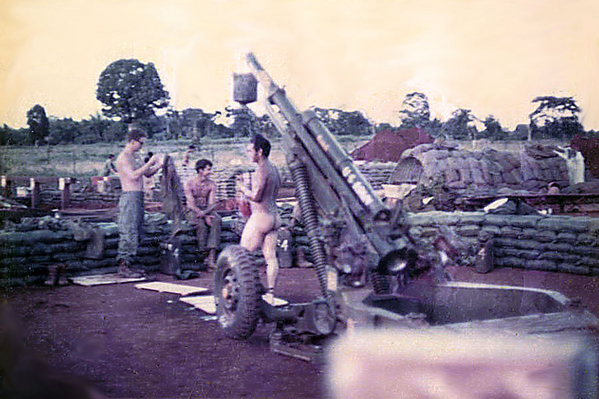 Out of uniform?
You won't find this method of showering in Ft Sill's FM 6-40.  Hanging a water can to the end of the howitzer tube is strictly an improvisation.  They would have to add another Chapter.
