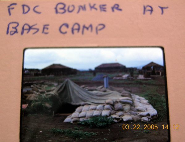 Underground Bunker - the orginal CONEX FDC concept
The next change for our FDC operations was CONEX containers.  We buried two (2) CONEX containers in Base Camp.  They were dug in with the help of a bulldozer.  They were facing each other, dropped into the hole and covered with sandbags.  We made a "sandbag staircase" to get back to the surface.  I don't know how this would work out in monsoon season.  Inside the containers, we used red lights at night and white lights during the day.   We  moved in our standard field tables for the charts and placed the radios on ammo boxes.
