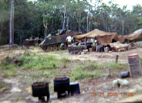 APC
In the background is an APC of the 135th.  To the center right is a piss tube.  You probably don't want to know what is in the cut-off barrels in the foreground.
