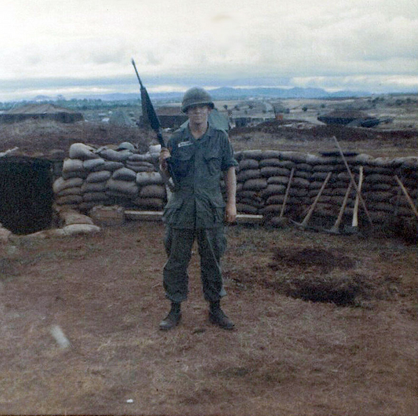 Base Camp - Christmas, 1966
PFC John Waldman ready to defend gun pit.  The hole behind him is likely from one of the blades of the 105mm towed howitzers.
