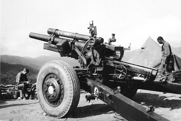 Beautiful sight
There it is...in all its glory...the 105mm howitzer, towed.  In the background is Sp4 Whitman Jones.  In the foreground is Sp4 Kurt Krabbe.  Both men are listed on the 1Oct67 ""A" Battery roster.  This is the #6 piece at LZ Corral.
