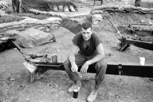 C-Rat time
Cpl John Kuntz "enjoying" his C-rations.  The trail of the howitzer serves as the "dinner setting".   LZ Corral, early March, 1967.
