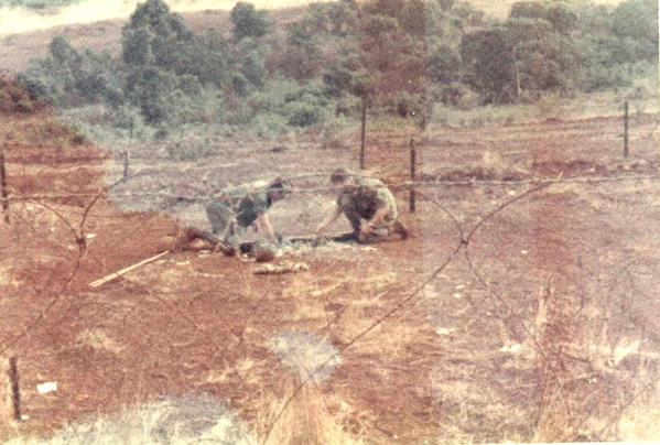 Attack on The Oasis
Policing up the explosives in the wire where the three NVA Sapper assassins were killed.  This was a diversion away from the main Attack on the Northwest Perimeter corner of the “Oasis”.


