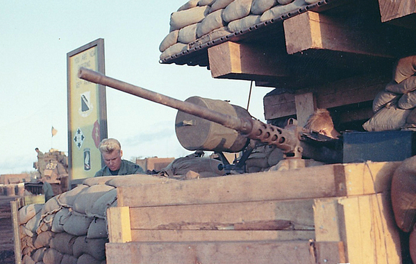 LZ Oasis: Guard Bunker w/ .50 cal machinegun overlooking runway
February, 1969.  In the background, you can see the insignia of the 1/69th, the 4th Inf Div, the 25th Inf Div and the 101st Abn.  The sign says: "YOU ARE NOW ENTERING THE 1/69th".  One night, I saw a tiger running down the runway.
