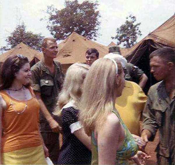 The Standown Ladies
These young beauties, out of uniform as they may be, are still a very welcome sight at LZ Oasis as the unit was "standing down".  Admiring are: Frank Adams, Terry Savely, and Bill Burdick.

