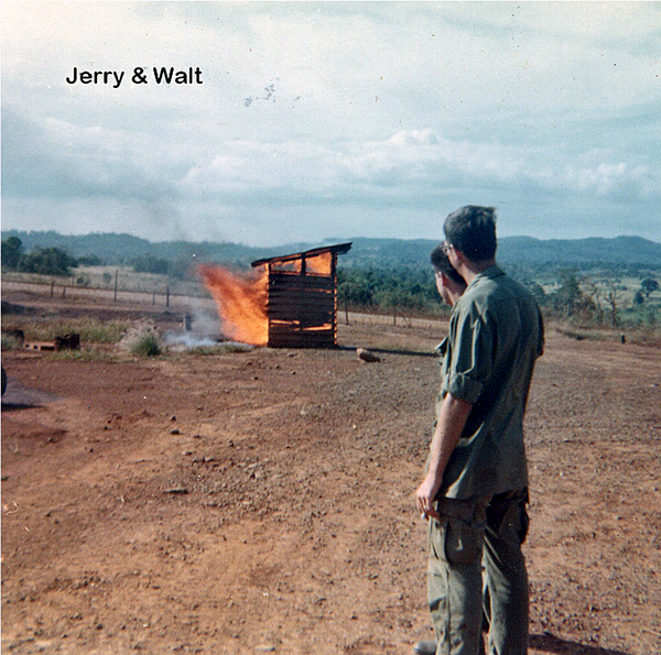 On fire
Jerry Genson & Walt Schneidereit watch fire.  A distillery it isn't.  If you guessed outhouse...correct!  Photo was taken in Nov, 1969 just hours before we left the Oasis for Camp Enari.
