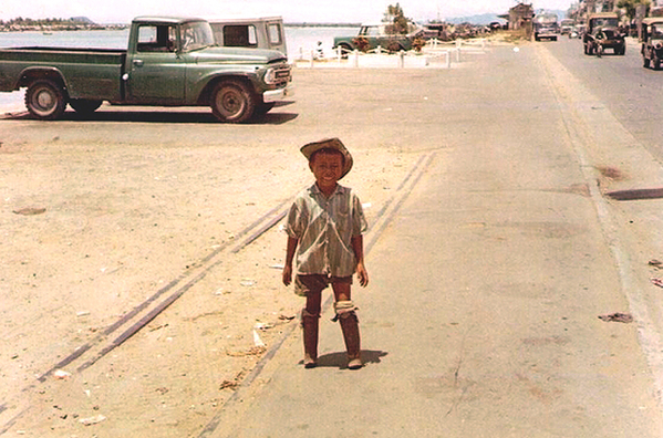 The Innocents of War
I took this photo on the docks at Da Nang. The little boy is standing on artificial legs...and smiling.

This was on my 2nd tour in Vietnam.
