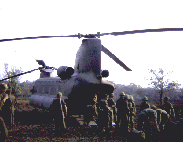 The old way
Back in the early stage of the war, cannoneers had to manually push their howitzer into the rear of a Chinook.  As time went by, the howitzers were slung underneath the Chinooks.
