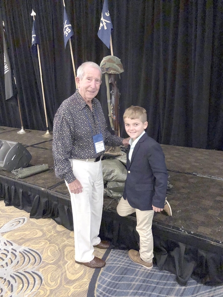 Dave Collins
C-1-35 Company Commander Dave Collins poses with his grandson David near the podium of the memorial to our lost soldiers.  Dave said his grandson "had a lot of questions" about what he saw at the Banquet ceremonies.

